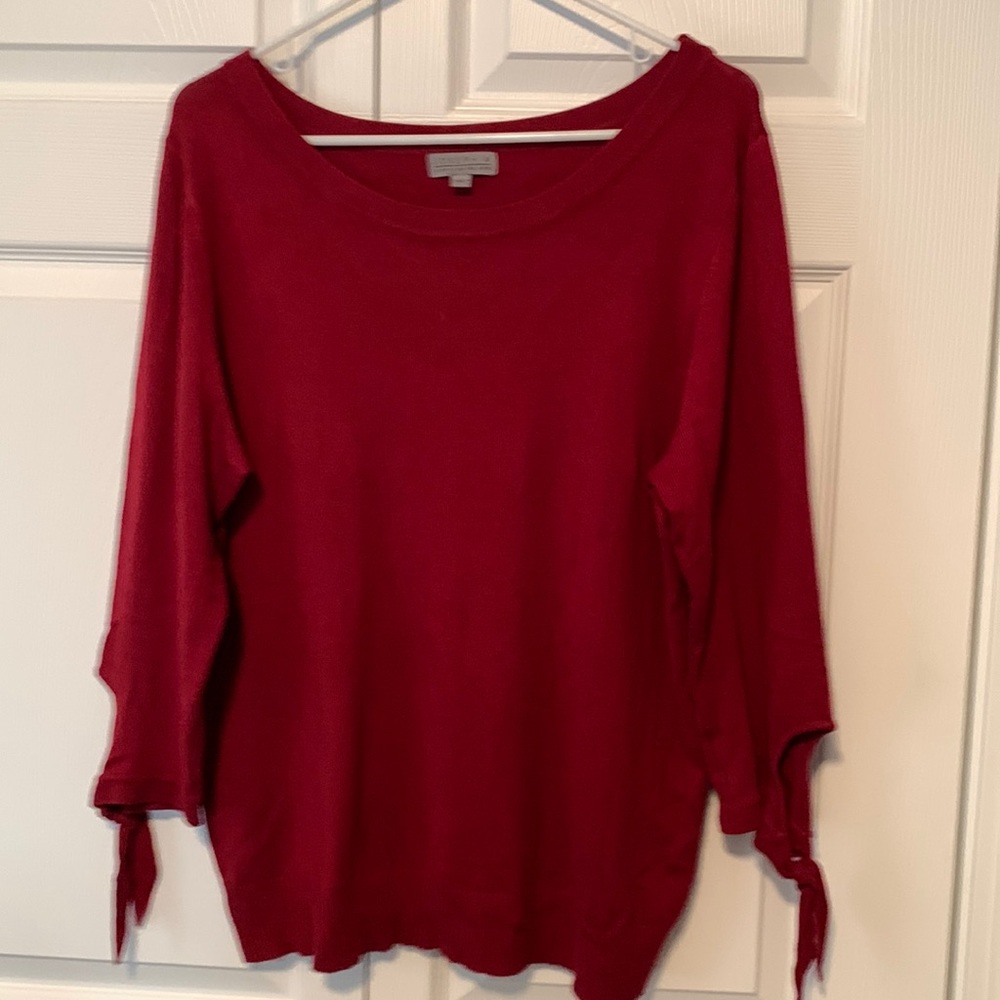 Red sweater with tie sleeves.